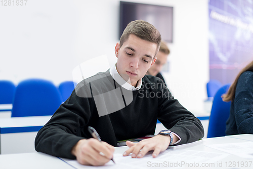 Image of male student writing notes