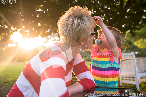 Image of mom and her little daughter using tablet computer