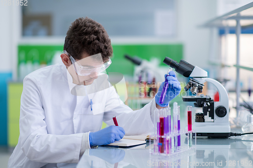 Image of student with protective glasses making chemistry experiment