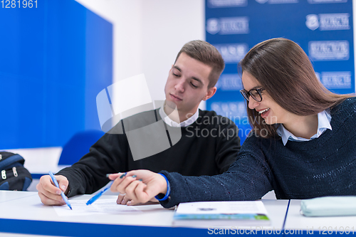 Image of young students writing notes