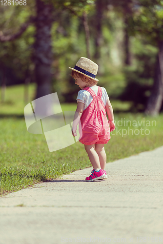 Image of little girl runing in the summer Park