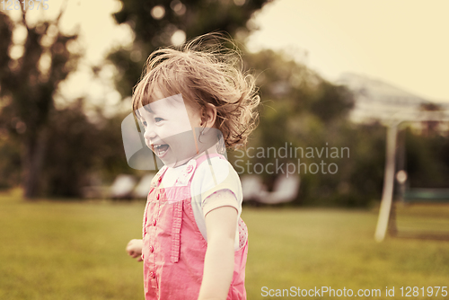 Image of little girl spending time at backyard