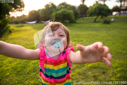 Image of little girl spending time at backyard