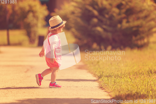 Image of little girl runing in the summer Park