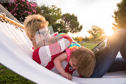 Image of mom and a little daughter relaxing in a hammock