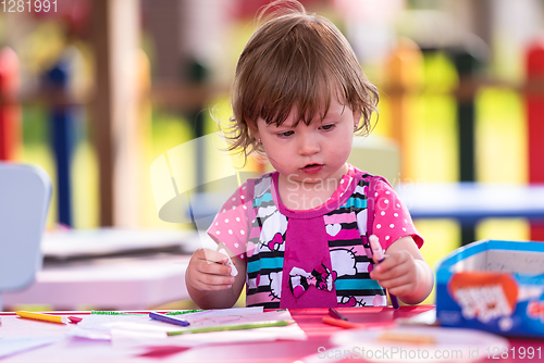 Image of little girl drawing a colorful pictures