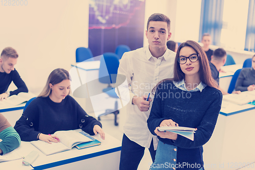 Image of young students writing notes