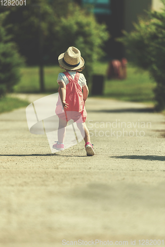 Image of little girl runing in the summer Park