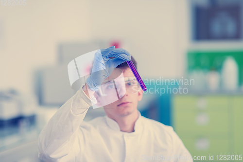 Image of student with protective glasses making chemistry experiment