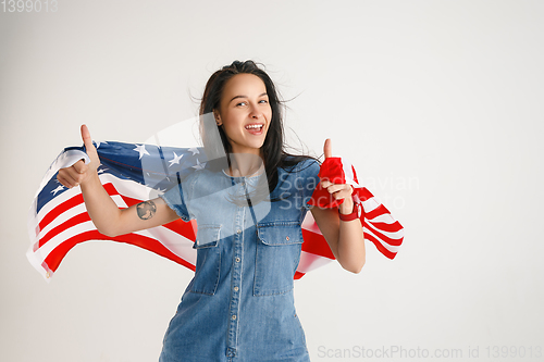 Image of Young woman with the flag of United States of America