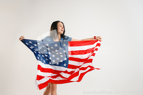 Image of Young woman with the flag of United States of America