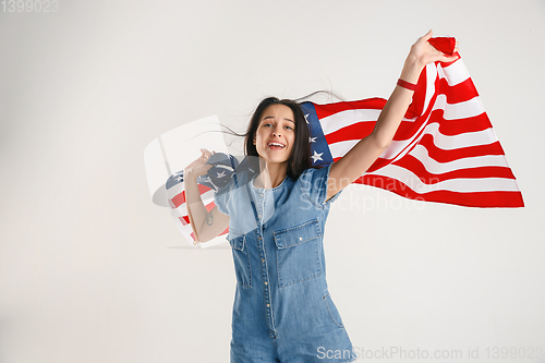 Image of Young woman with the flag of United States of America