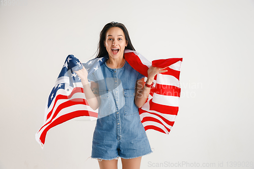 Image of Young woman with the flag of United States of America