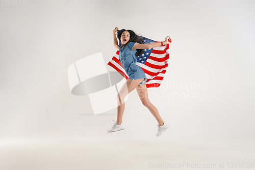 Image of Young woman with the flag of United States of America