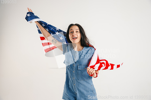 Image of Young woman with the flag of United States of America