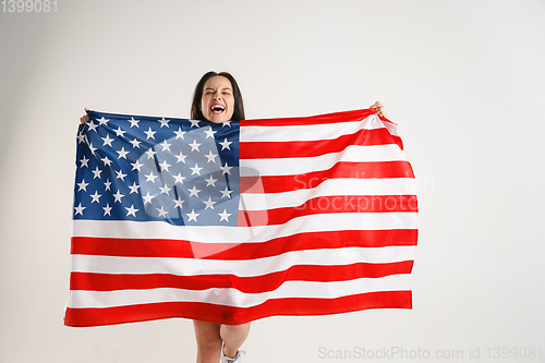 Image of Young woman with the flag of United States of America