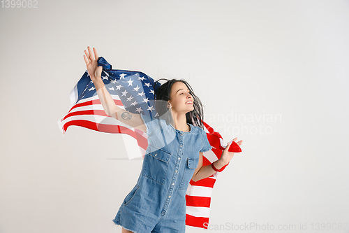 Image of Young woman with the flag of United States of America