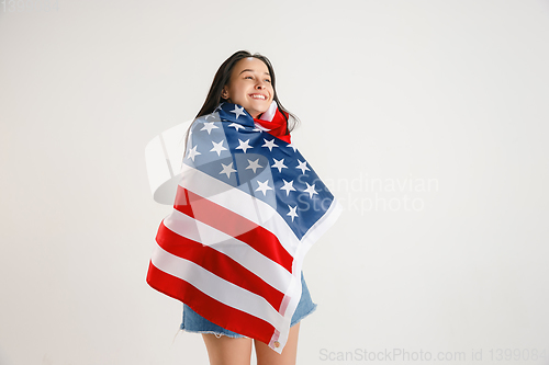 Image of Young woman with the flag of United States of America