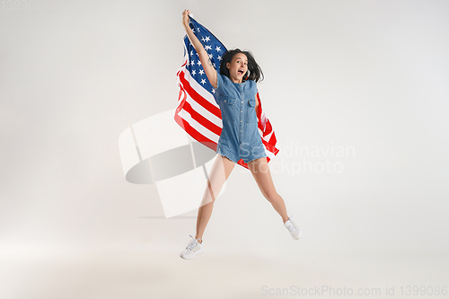 Image of Young woman with the flag of United States of America