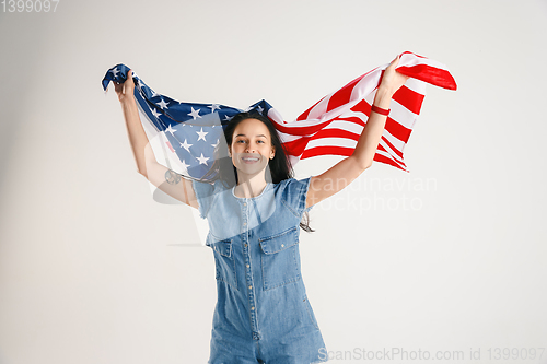 Image of Young woman with the flag of United States of America