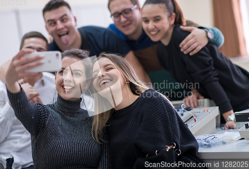 Image of young happy students doing selfie picture