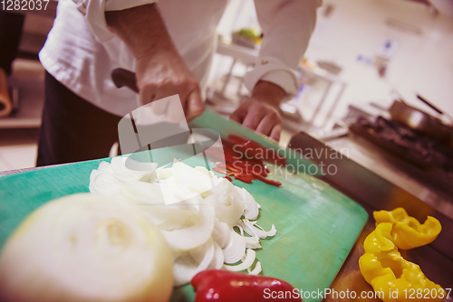 Image of Chef hands cutting fresh and delicious vegetables