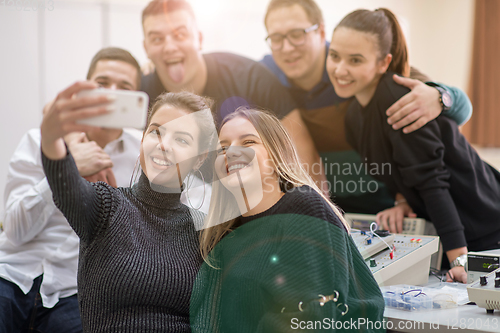 Image of young happy students doing selfie picture