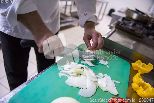 Image of Chef hands cutting fresh and delicious vegetables