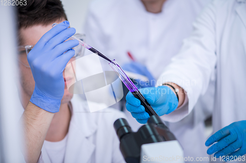 Image of student with protective glasses making chemistry experiment