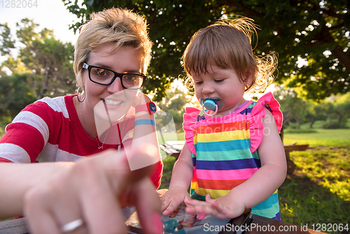 Image of mom and her little daughter using tablet computer