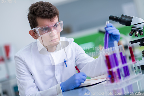 Image of student with protective glasses making chemistry experiment