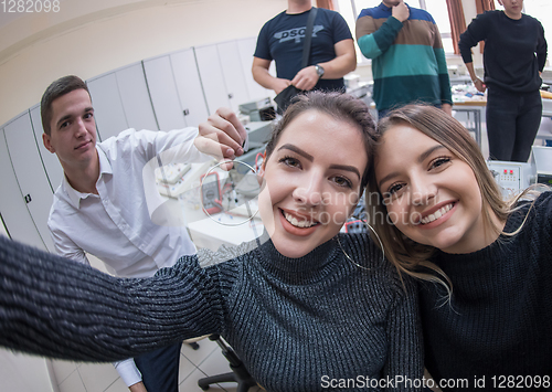 Image of young happy students doing selfie picture