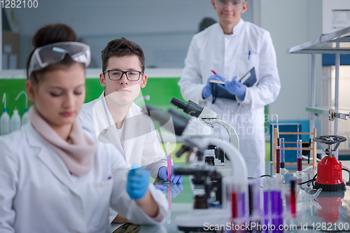 Image of Group of young medical students doing research