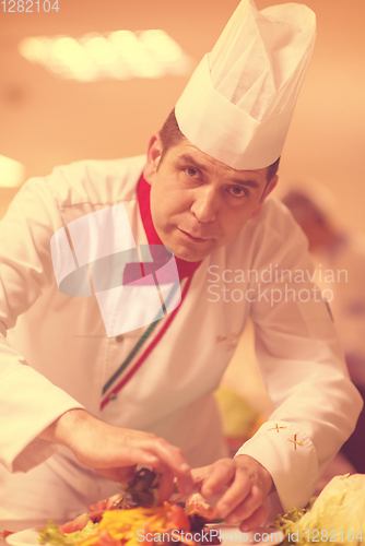 Image of chef serving vegetable salad