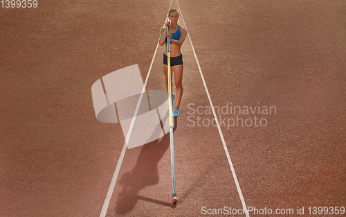 Image of Female high jumper training at the stadium in sunny day