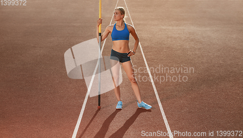 Image of Female high jumper training at the stadium in sunny day