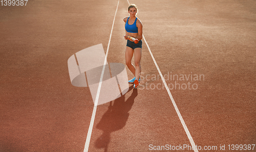 Image of Female high jumper training at the stadium in sunny day