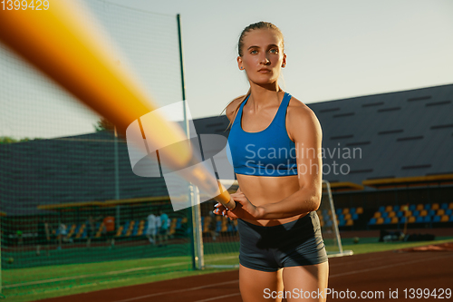 Image of Female high jumper training at the stadium in sunny day