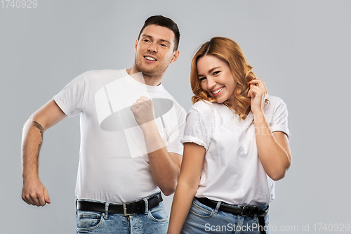 Image of portrait of happy couple in white t-shirts dancing