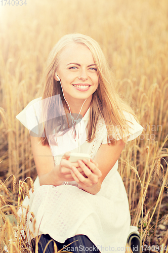 Image of happy woman with smartphone and earphones