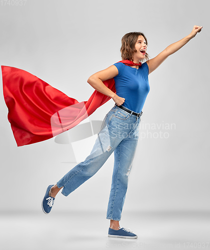 Image of happy woman in red superhero cape