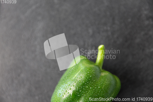 Image of close up of green pepper on slate stone background