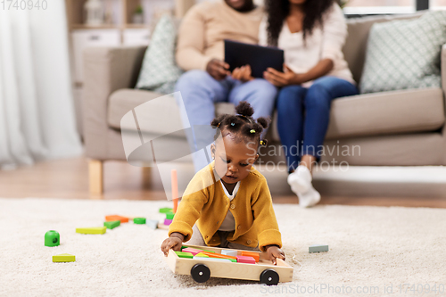 Image of family with tablet pc and toy blocks at home