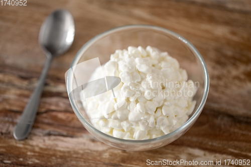 Image of close up of cottage cheese in bowl on wooden table