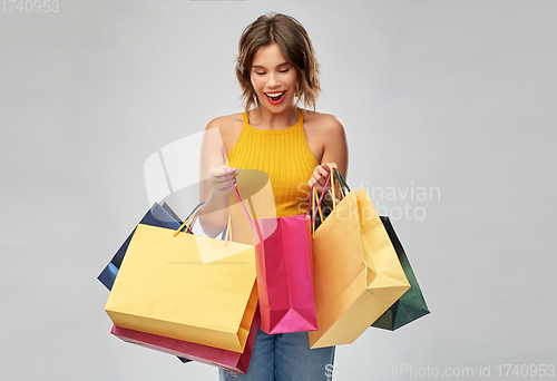 Image of happy smiling young woman with shopping bags