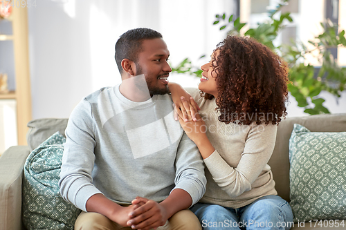 Image of happy african american couple talking at home