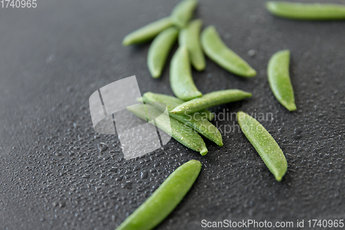 Image of peas on wet slate stone background