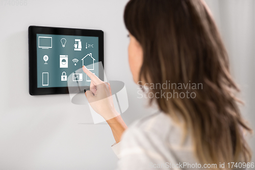 Image of woman using tablet computer at smart home