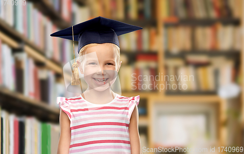 Image of girl in bachelor hat or mortarboard at library