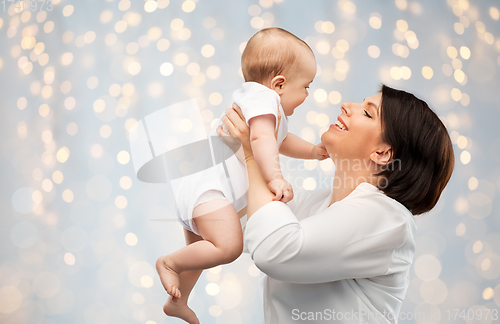 Image of happy middle-aged mother with little baby daughter